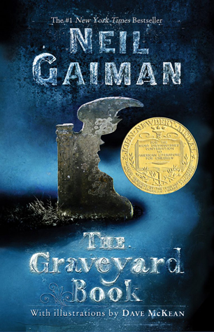 The Graveyard Book book cover (an old grave with a cutout part in the shape of a young boy's face, with shadowy fog in the background)