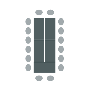 Tables joined in a block and surrounded by chairs