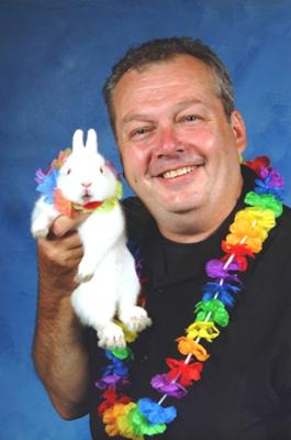 Magician Richard Landry holding his bunny rabbit, Snowball 