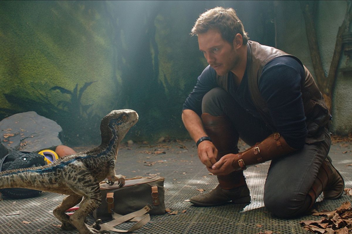 Chris Pratt with a baby dinosaur 
