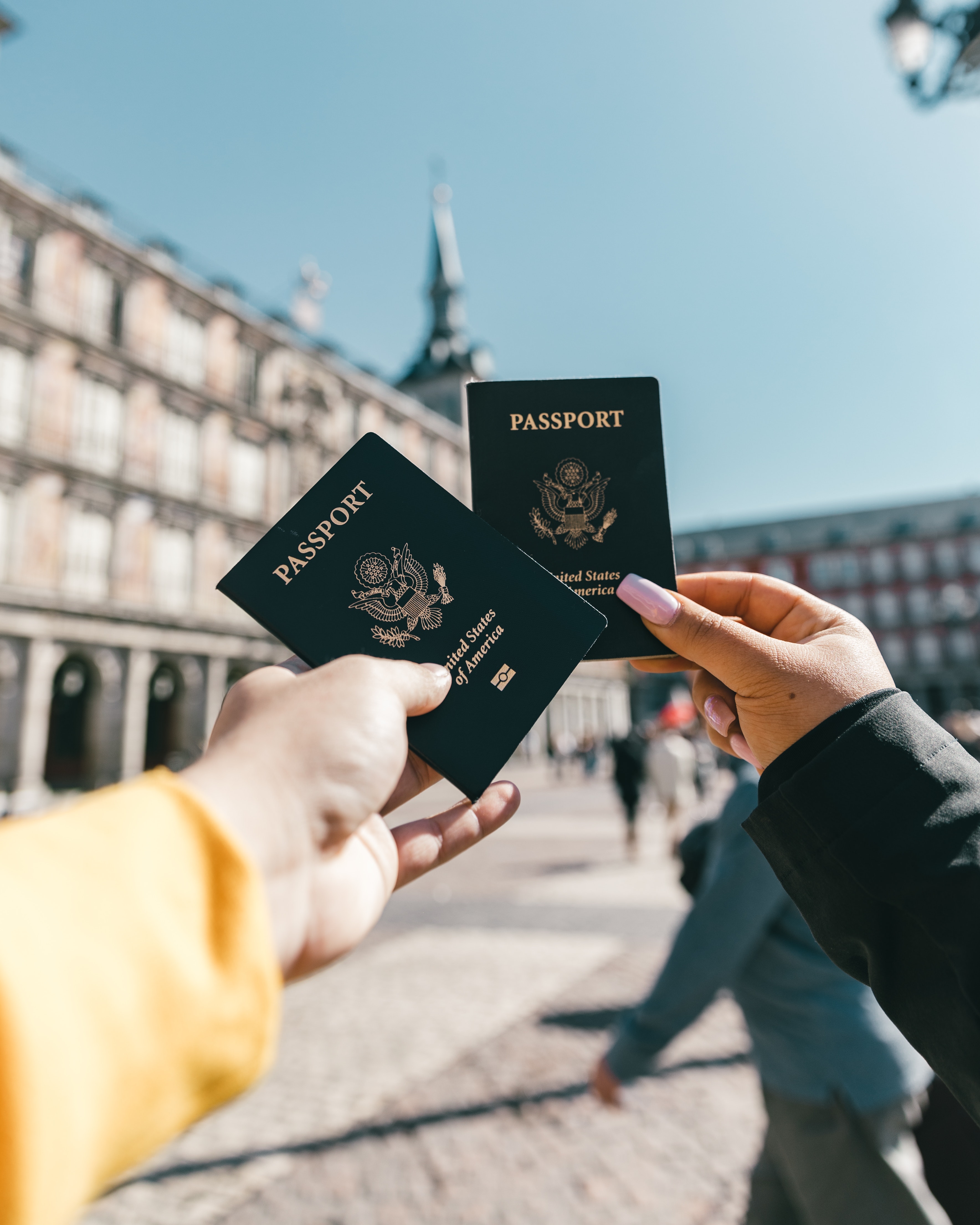 Two people holding up passports