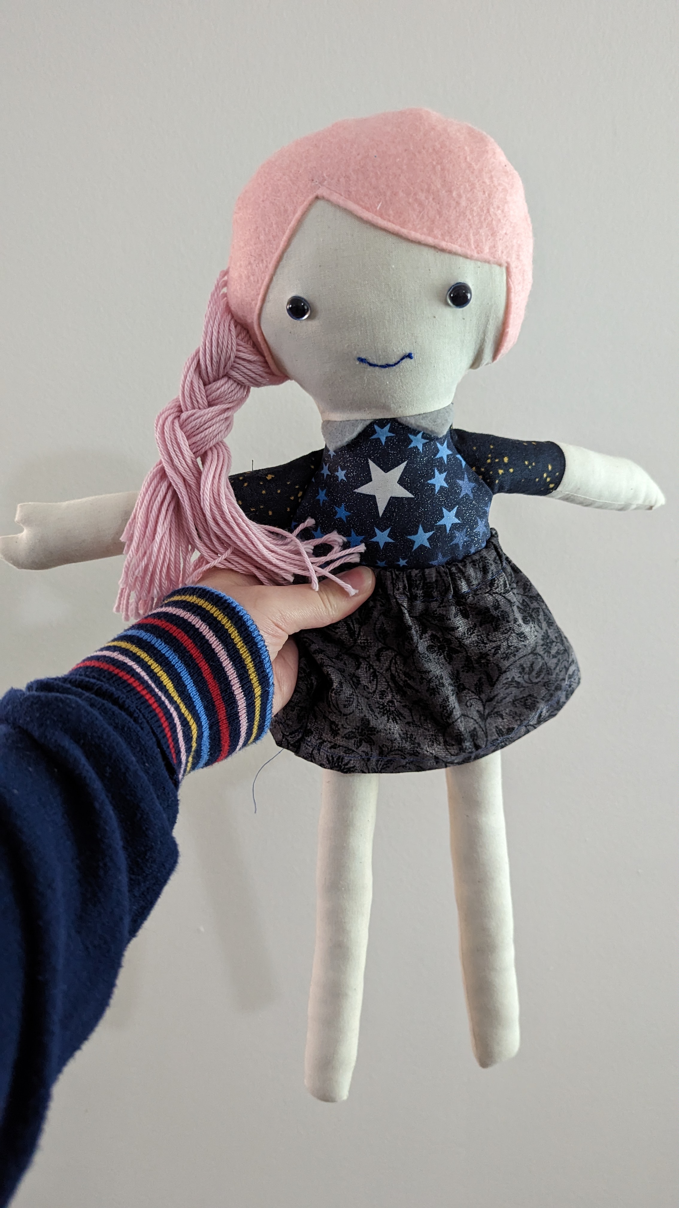 Photo of hand-sewn rag doll with pink yarn hair