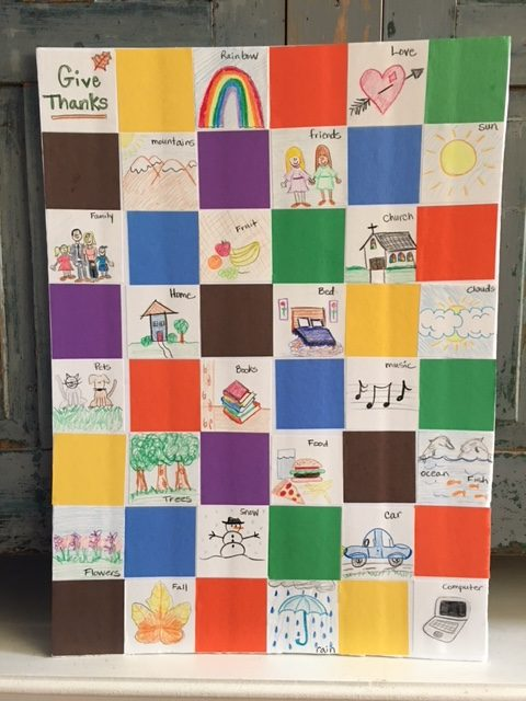 A multicolored quilt with various illustrations in the squares