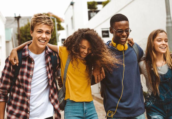 group of teens smiling and walking