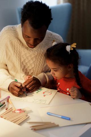 A father and daughter drawing together