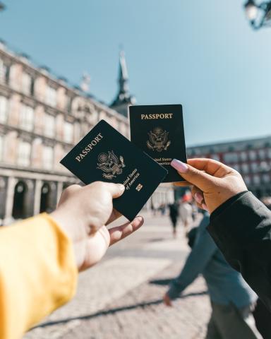 Two people holding up passports