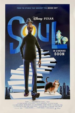 A man walks a keyboard-shaped road with a cat at his side