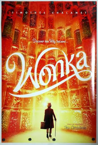 A man wearing a top hat and carrying a cane and suitcase faces a large wall of candy jars. The word "Wonka" is in script above his head. 