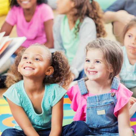 Young children listen to a story.