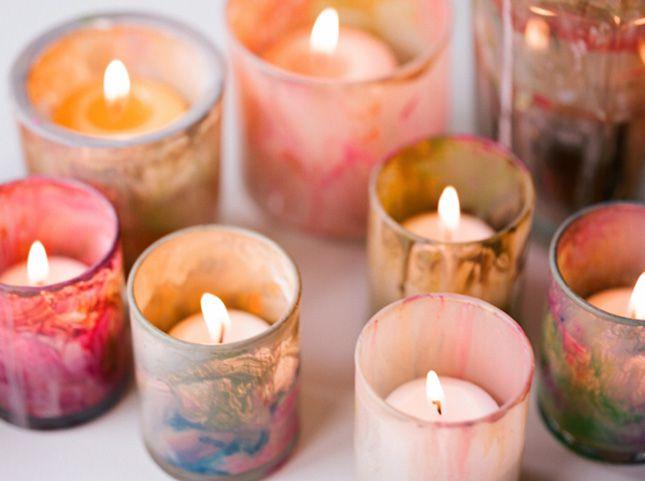 Painted candle holders with burning candles inside 